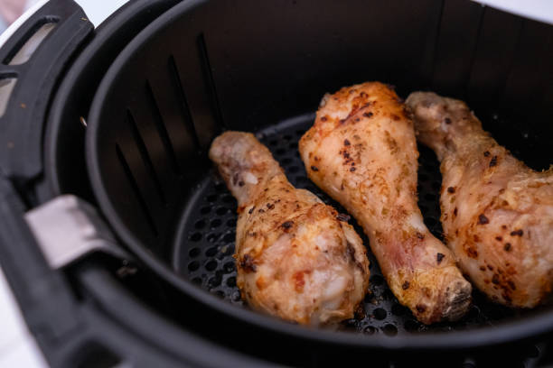istock Frying chicken legs in white airfryer in close-up 2196545215