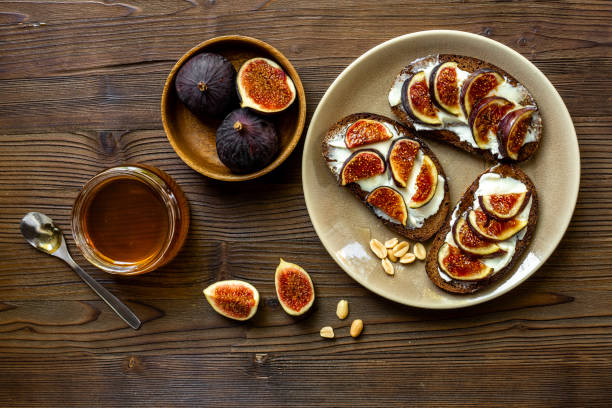 istock Breakfast with figs and cheese toasts with honey, top view 2196548260