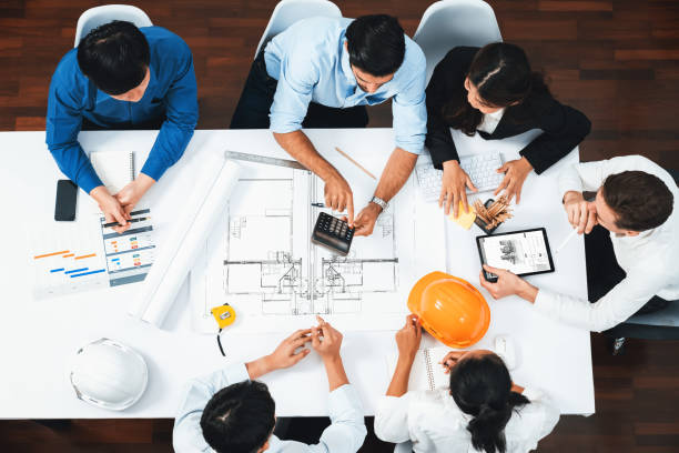 istock Diverse group of civil engineer and client working on architect. Prudent 2196549561