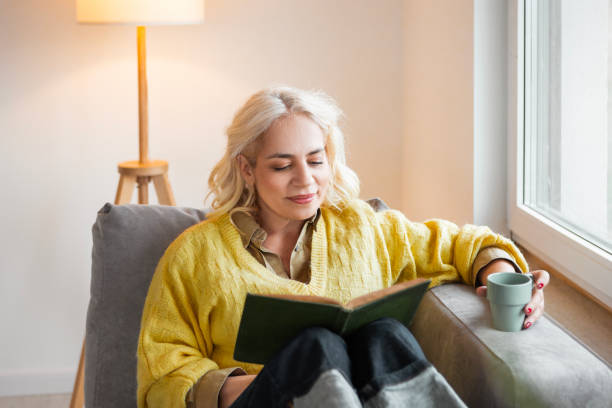 istock Woman Enjoying a Book and Coffee 2196549971