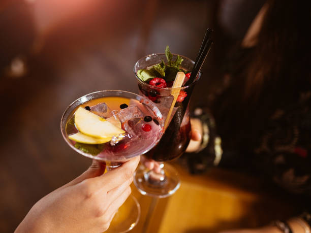 istock Two Hands Toasting with Elegant Cocktails in a Festive Ambiance 2196550851