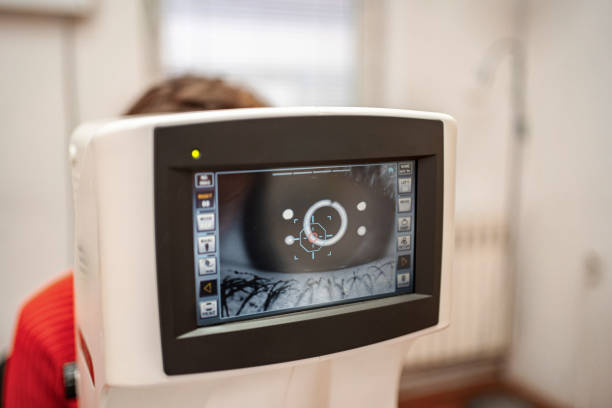 istock Optician examining patient's eye with modern equipment for accurate diagnosis 2196552552