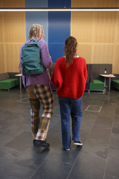 istock Man and woman walking in community center 2196556050