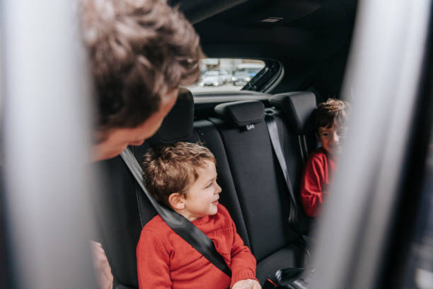 istock Father putting his little son in car 2196557421