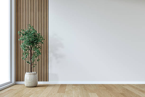 istock A retro-modern minimalist unfurnished interior with a potted plant by a large window, in front of an empty, white plaster, partly 
 hardwood paneled wall background with copy space 2196558409