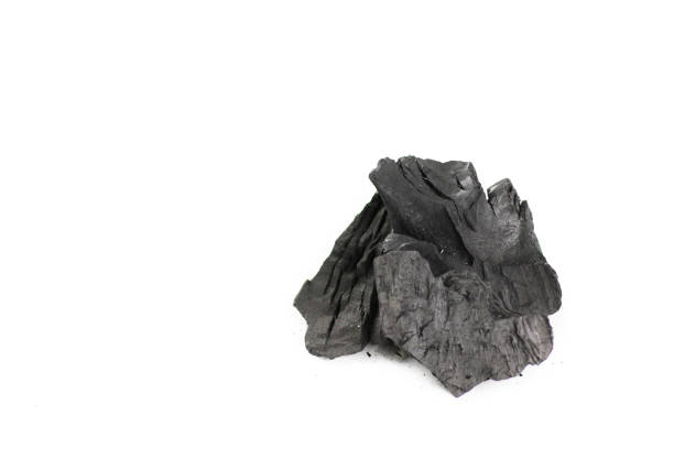 istock Isolated pieces of black charcoal resting on a clean white background, showcasing its rough texture and deep, rich color. Often used for grilling, art, and filtration, charcoal symbolizes both energy and transformation. 2196559758