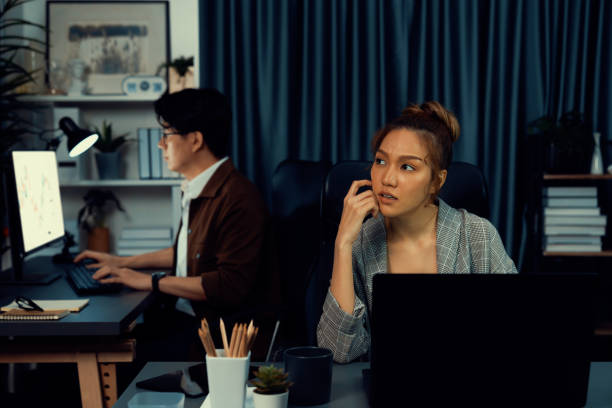 istock Businesswoman focusing computer with coworker working at back side. Infobahn. 2196560197