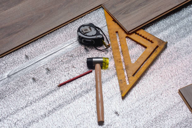 Close-up view of tools and materials used for laminate flooring installation