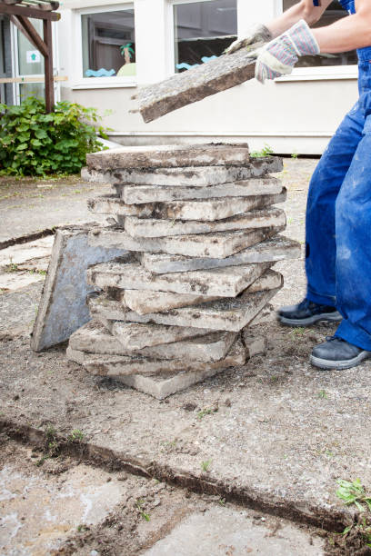 istock Break up and removing old paving stones from the ground in a backyard 2196564390