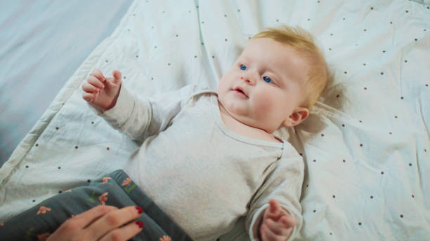 istock The baby lies on its back and laughs. 2196568285