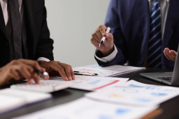 istock Businessman and financial advisor analyzing financial charts and graphs on document during meeting. Businesspeople are discussing financial data and pointing at charts and graphs on financial reports. 2196569514