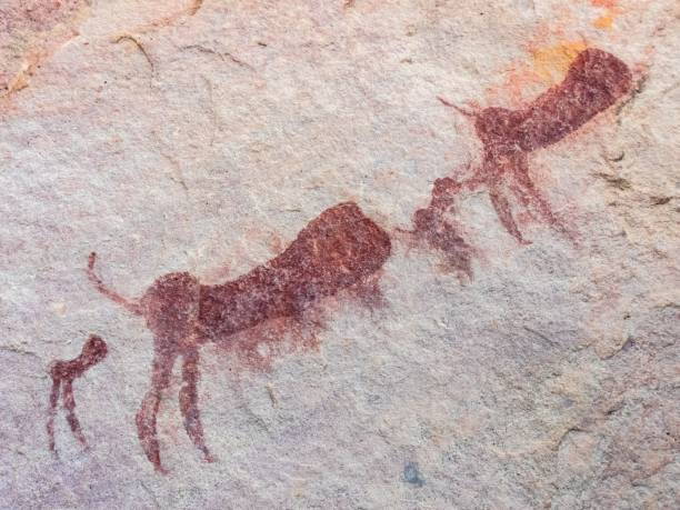 istock Ancient rock art depicting animals in a prehistoric style on a textured stone surface. 2196573702