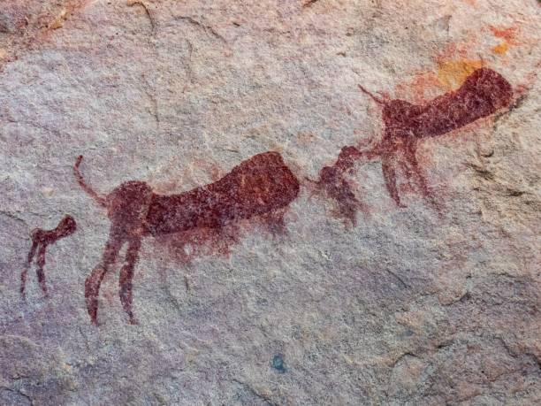istock Ancient rock art depicting animals on a textured stone surface, showcasing prehistoric creativity. 2196573705