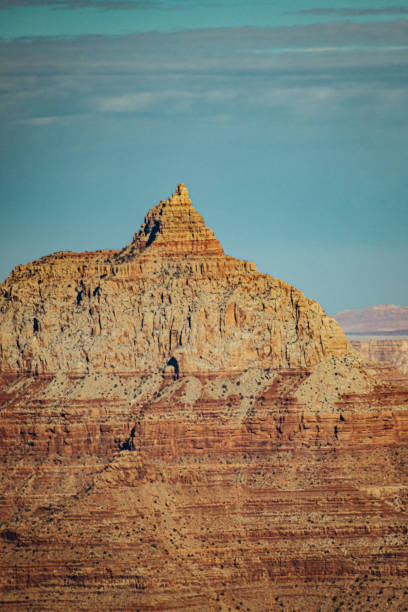 Rock formation at the Grand Canyon on a sunny day against a blue sky.