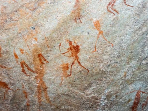 istock Ancient rock art depicting hunters with bows and arrows, showcasing. 2196573718