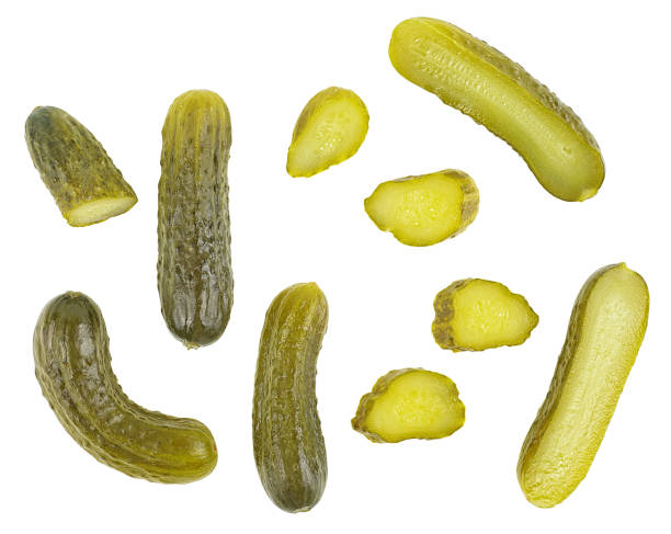 istock Set of pickle cucumbers and slices isolated on a white background. Marinated small cut green cucumbers, top view. 2196577820
