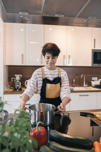 istock Teenager preparing meal in modern kitchen 2196578194