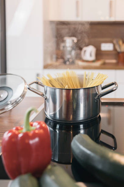 istock Cooking spaghetti for dinner in modern kitchen with zucchini and pepper nearby 2196578251