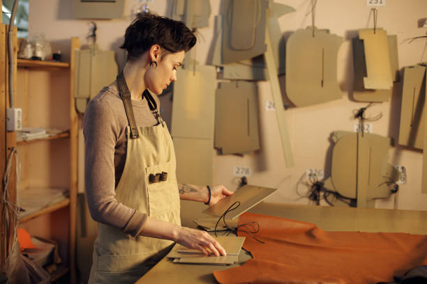 istock Concentrating on Crafting Leather Accessories in Workshop 2196579090