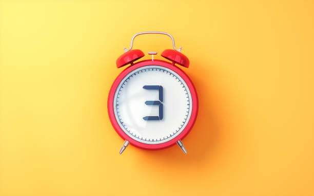 istock Red Alarm Clock with White Inside and Black Digit 3 on Yellow Soft Background 2196580102
