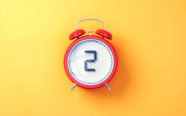 istock Red Alarm Clock with White Inside and Black Digit 2 on Yellow Soft Background 2196580115