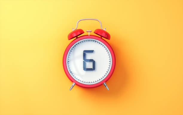 istock Red Alarm Clock with White Inside and Black Digit 6 on Yellow Soft Background 2196580144