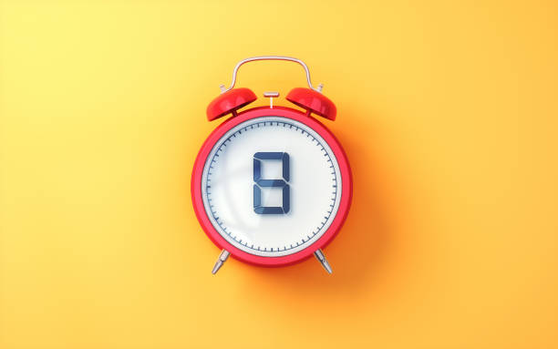 istock Red Alarm Clock with White Inside and Black Digit 8 on Yellow Soft Background 2196580181