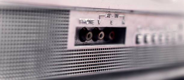 Worn vintage television rear panel featuring dusty audio-video inputs and headphone jack, revealing aging analog electronics and technological obsolescence