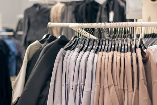 istock Jackets on hangers in a shop window 2196584036