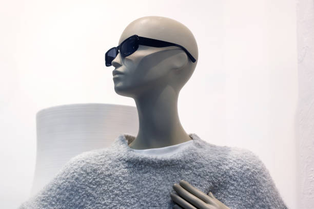 Female mannequin in gray jacket close up, copy space