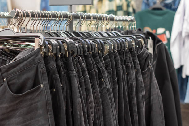 istock Pants hanging on hangers in a store 2196584152