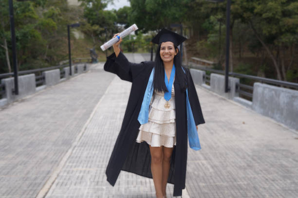 istock Graduate standing girl at graduation ceremony 2196585055