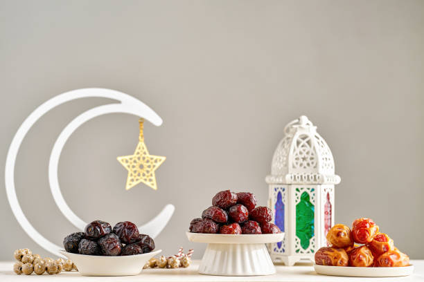 istock Ramadan kareem background . White Ramadan moon decor with Islamic prayer beads , lantern fanous and dried date fruits 2196586742