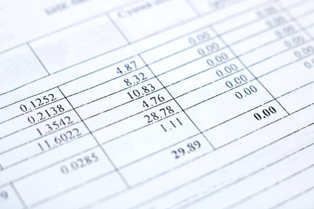 A closeup of a rectangle paper document with numbers in electric blue font. The pattern of parallel numbers creates a publication material property