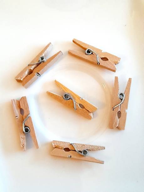 istock Small wooden clothespins with white background 2196587542