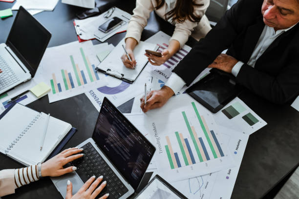 istock Employees Examining Paperwork and Documents on Busy Day At Office 2196588751