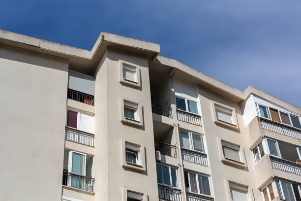 istock Residential building in Bar, Montenegro, featuring white facades, balconies, and windows under a clear blue sky, showcasing urban living 2196589710