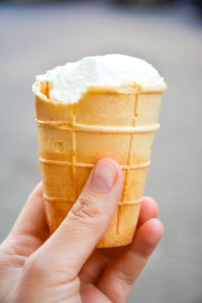 istock close-up of a hand holding an ice cream cone 2196589796