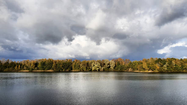 istock Storm Clouds Over Tranquil Lake in Autumn 2196590565