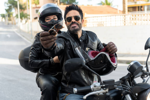 istock Bikers couple sharing sunglasses on a motorcycle 2196591374