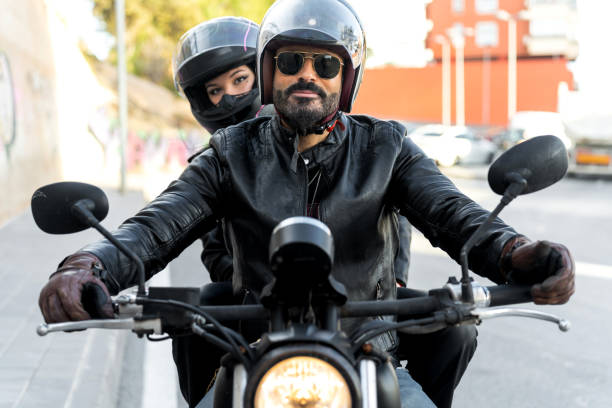 istock Bikers couple riding motorcycle wearing leather jackets and helmets 2196591382