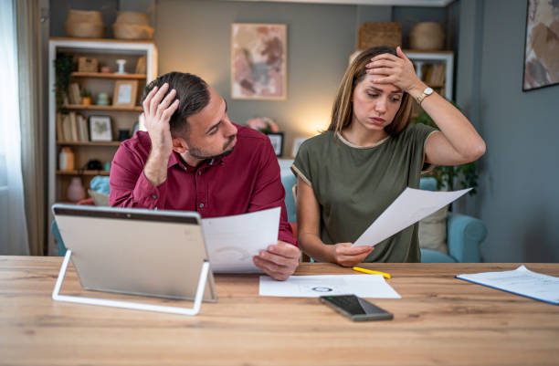 istock Worried young couple manages home finances 2196594200