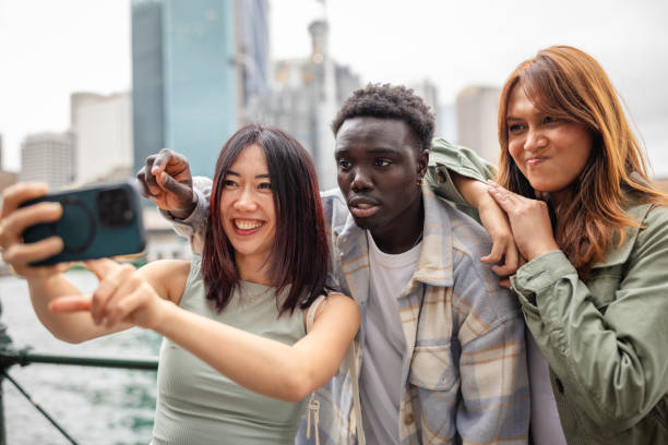 istock Friends enjoying a joyful moment together while exploring Sydney's vibrant waterfront 2196594767