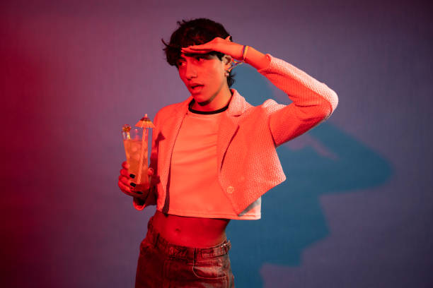 istock Stylish person holding tropical drink and looking away 2196597554