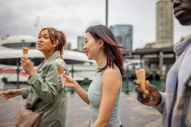 istock Joyful friends enjoying ice cream while exploring Sydney's waterfront on a pleasant weekend day 2196598954