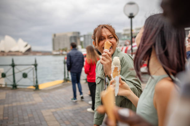 istock Joyful young adults enjoying ice cream along the Sydney waterfront during a cloudy weekend exploration 2196601814