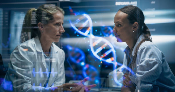 istock Physician And Patient Examine A Holographic Dna Model. AI-Powered Genomic Analysis Highlights Mutation Hotspots And Therapeutic Targets In Real-Time, Precision Medicine And Targeted Gene Therapies. 2196602690