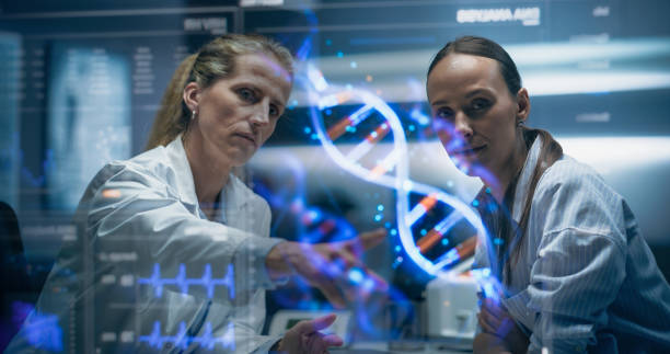 istock Physician And Patient Examine A Holographic Dna Model. AI-Powered Genomic Analysis Highlights Mutation Hotspots And Therapeutic Targets In Real-Time, Precision Medicine And Targeted Gene Therapies. 2196602729