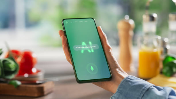 istock Hand Holds a Smartphone Displaying an AI Chatbot Interface. Device Shows Recipe Ingredients and Instructions, Ai Assistant Provides Culinary Guidance. Technology Helps Mobile Phone User 2196603363