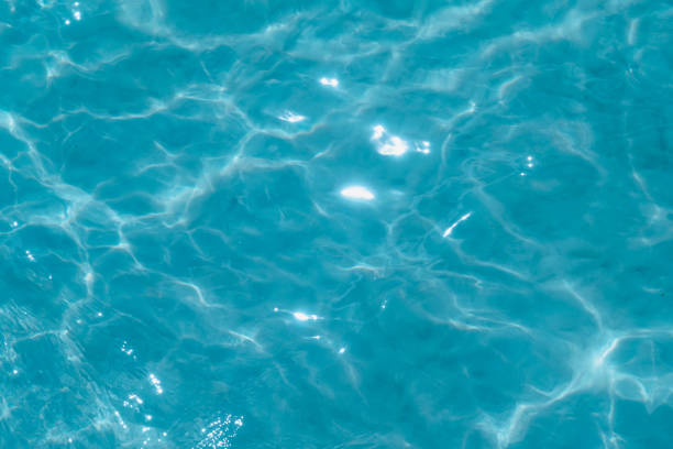 istock Overhead view of blue water surface abstract. Wave on moving water surface close up in the middle of the screen. Blue ocean water with waves background 2196608945